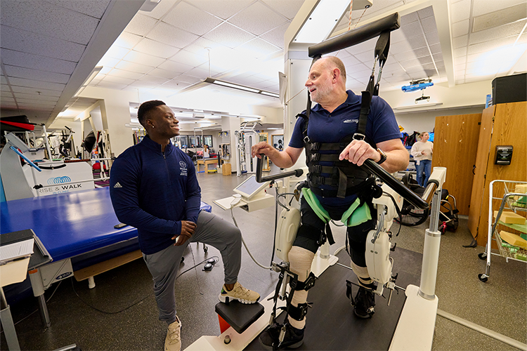 Nick Thomas, Exercise Physiologist, works with Jimmy Garland using a Lokomat, a robotic gait training device that helps patients learning how to walk again. 