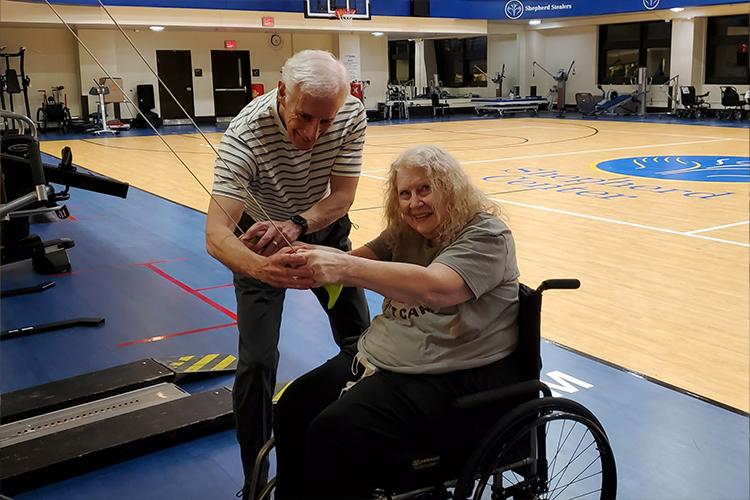 Donna Luttrell works out with the help of her Fitness Buddy, Doyle Mote, at Shepherd Center's ProMotion Fitness Center.