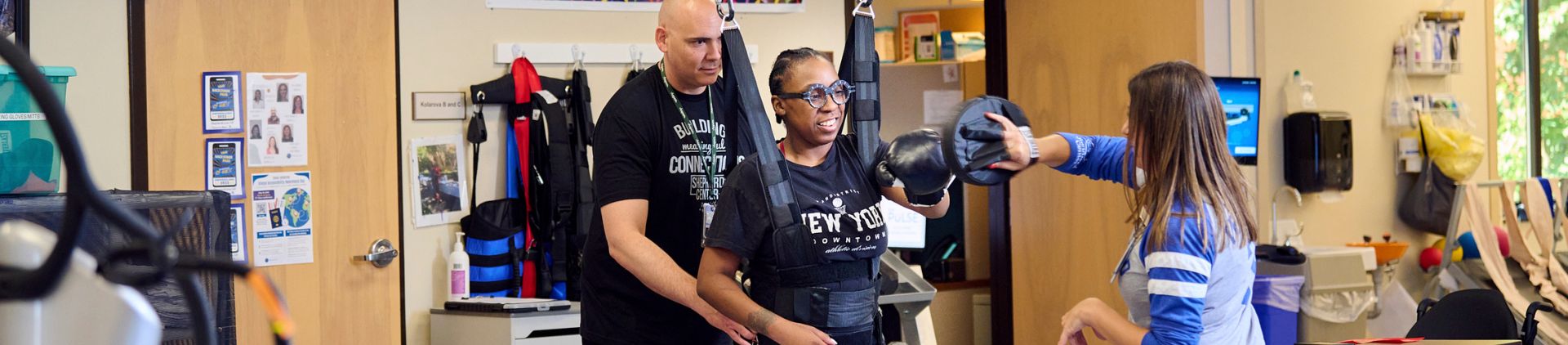 Occupational Therapist Jennifer Roane and Physical Therapist Don Archer work as a team with Karen Etheridge using a ZeroG Gait and Balance System that provides dynamic support that allowing patients to practice real-world activities in a 