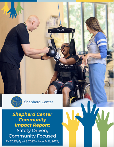 A patient smiles as she first bumps her therapists while wearing boxing gloves during a therapy session with the words &quot;Shepherd Center Community Impact Report: Safety Driven: Community Focused FY2023&quot;