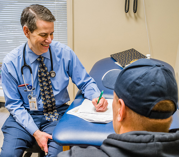 Dr. Michael Yochelson discusses treatment with a patient.