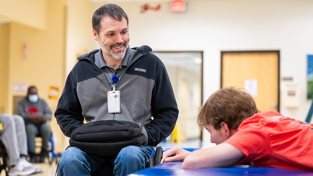 Peer support lead David Carter speaks to a patient at the Shepherd Center.