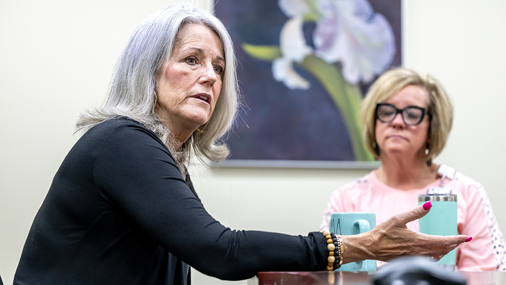 Peer support staff (from left) Mariellen Jacobs and Kim Ross speak in a meeting at the Shepherd Center.