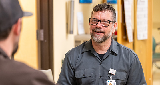 Peer support lead Pete Anziano speaks to a patient at the Shepherd Center.